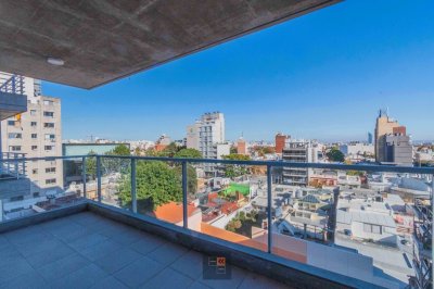 Edificio de viviendas de 1 y 2 dormitorios con patio verde.